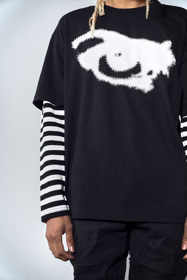 Close up of black oversized long sleeve tshirt with graphic print and mock stripe layered sleeves