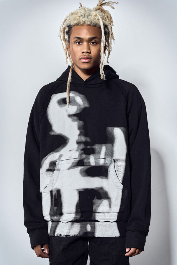 Close up of oversized black hoodie with white graphic print
