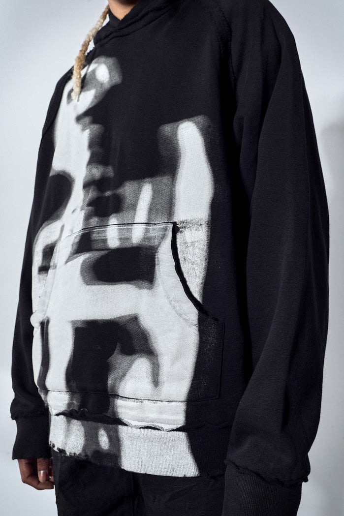 Close up of oversized black hoodie with white graphic print