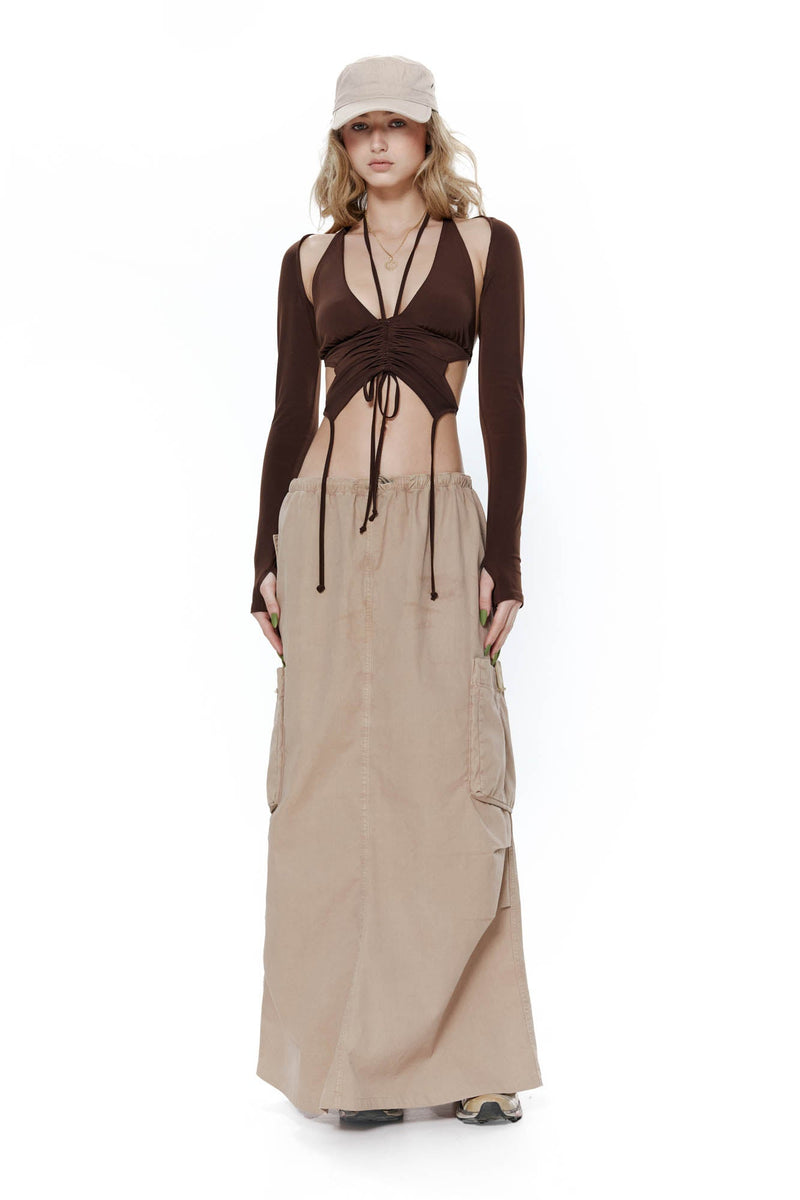 Light brown parachute style maxi skirt with drawcord waistband. Styled with the brown willow butterfly crop top and khaki baker boy hat.