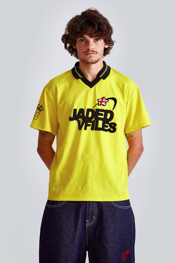 Male wearing a yellow jacquard argyll short sleeve football shirt with Jaded x VFiles logo. 