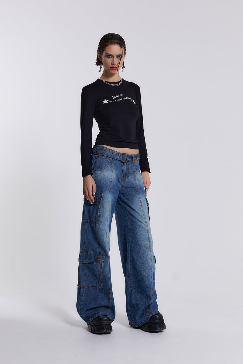 Female model wearing blue washed chambray denim skater fit jeans with belt detail. 