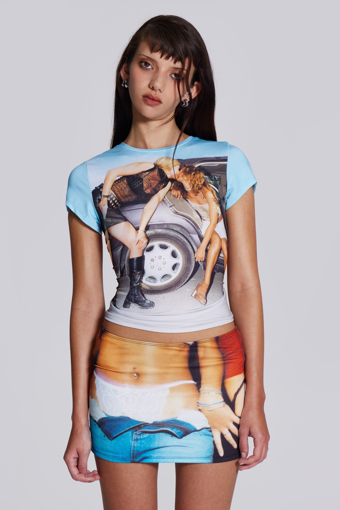 Female model wearing shrunken short sleeve t-shirt, with two women kissing graphic print.