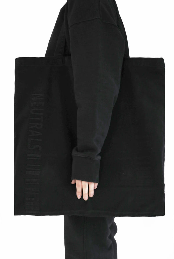 Dust black extreme oversized tote bag with embroidered branding detail. 