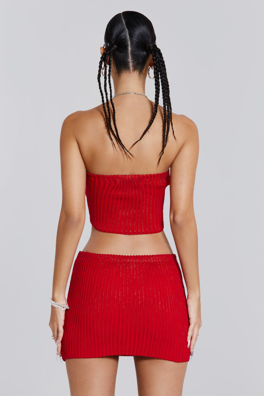 Female wearing red metallic knitted zip off bandeau mini length dress. 