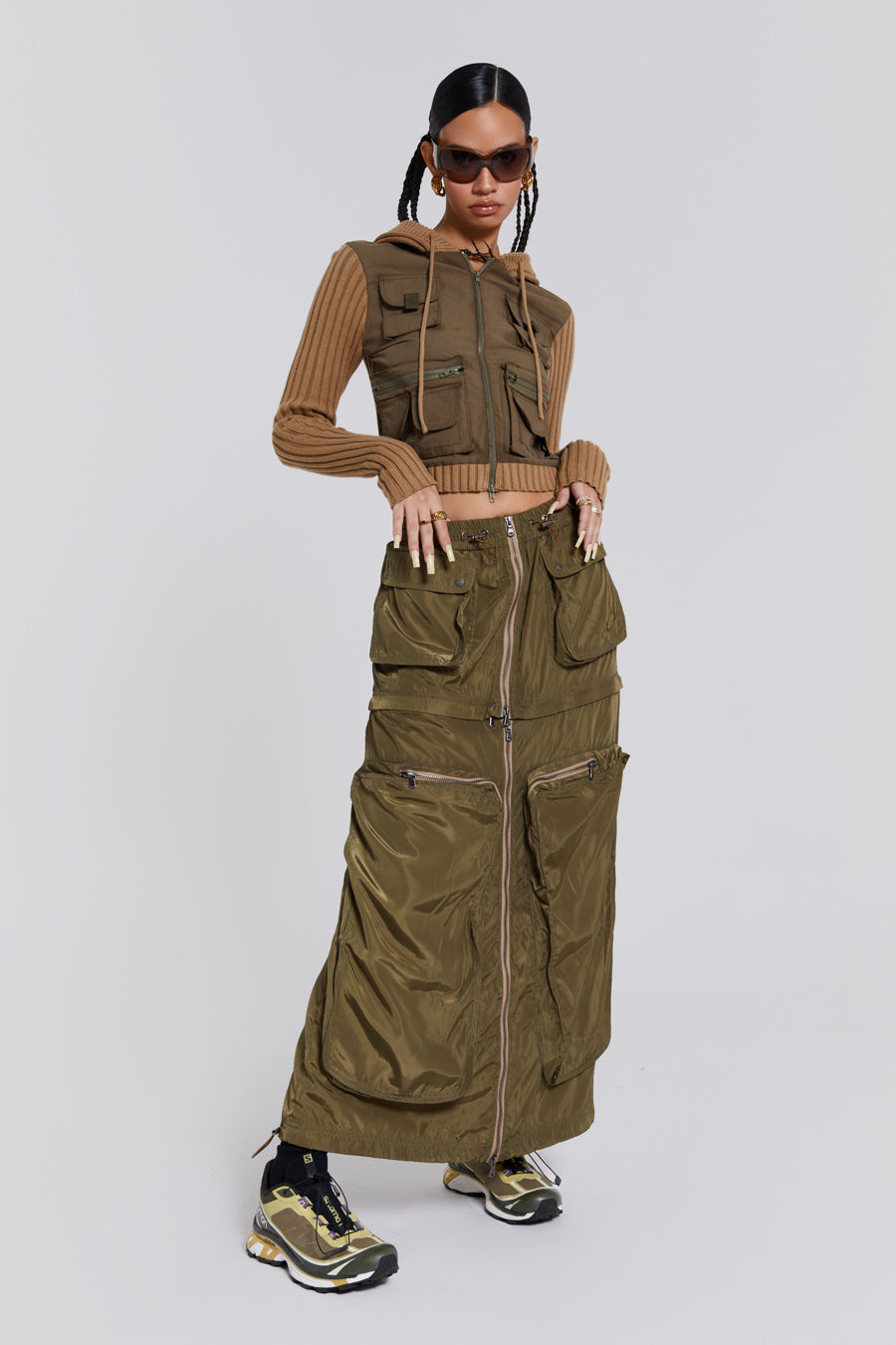 Female wearing a shiny khaki green pocket detail cargo midi skirt. Styled with a khaki green cargo jacket. 