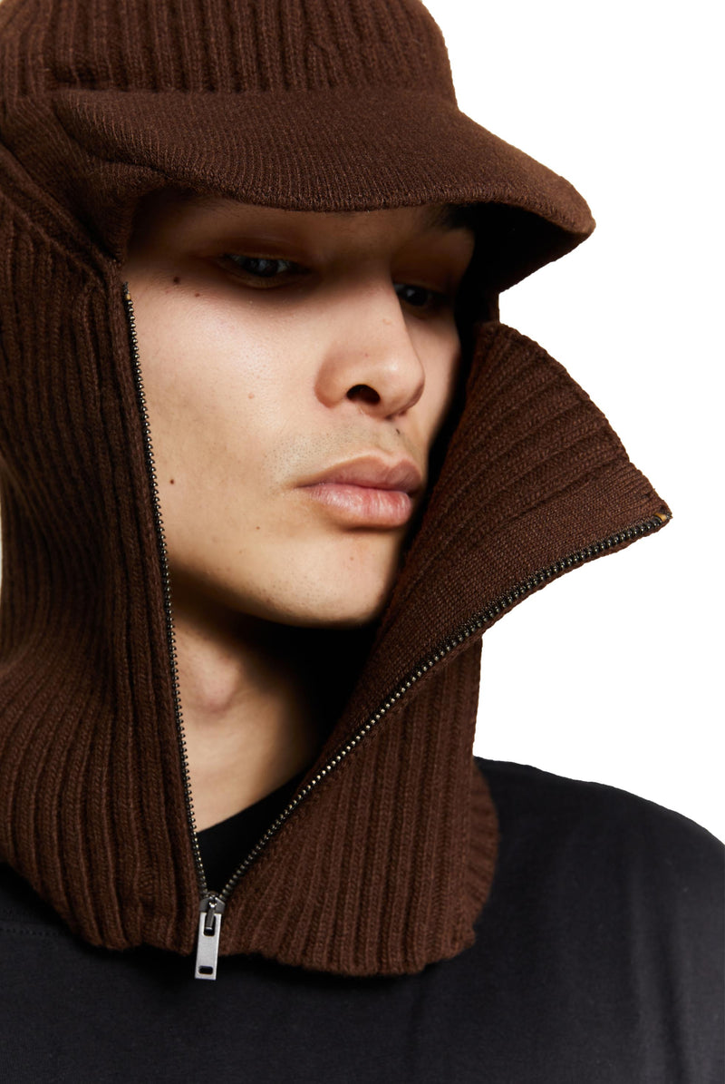Brown knitted balaclava with peak and zip up detail. 