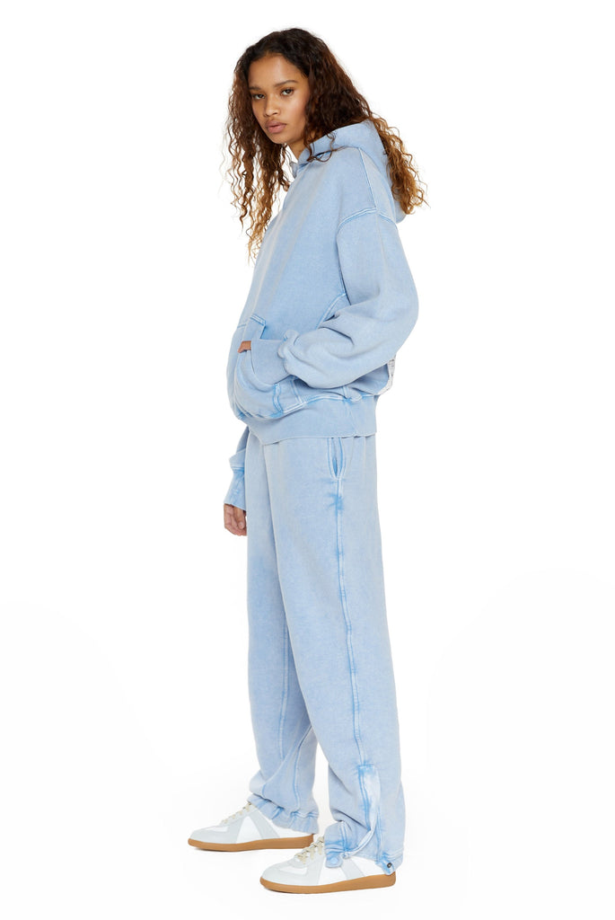 Powder blue cuffed joggers, styled with the matching oversized hoodie.