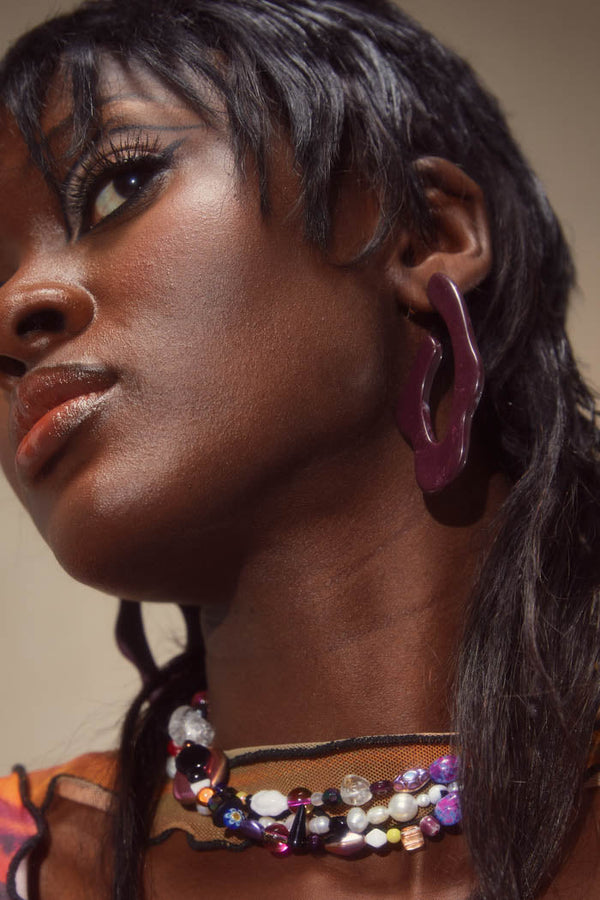 Dark red and brown resin swirl shaped earrings. 