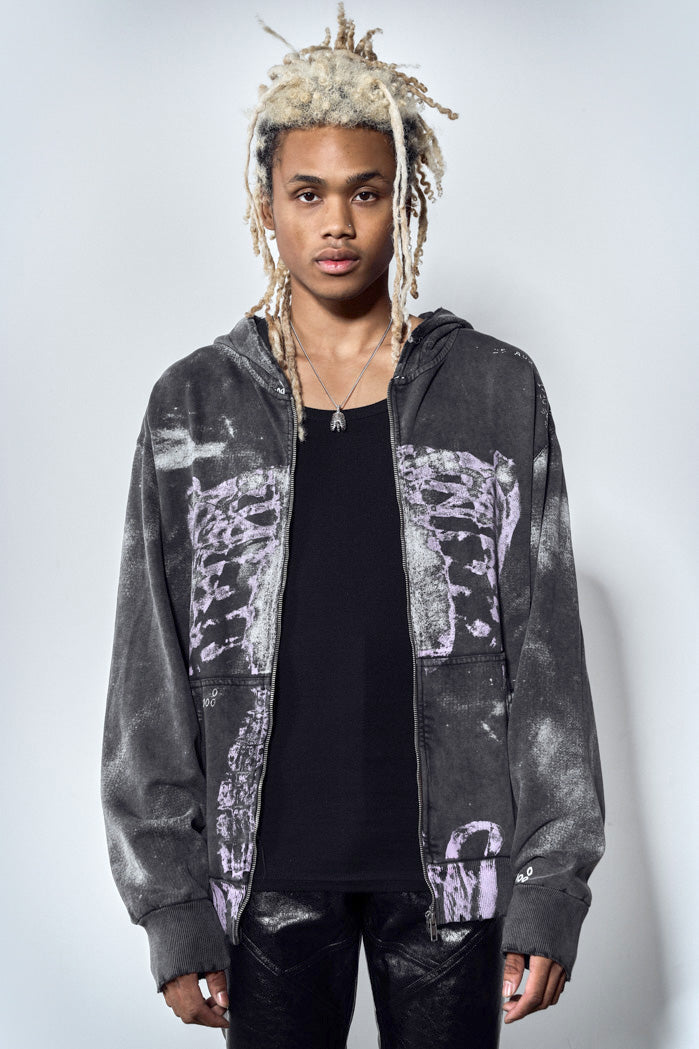 Close up of acid wash black zip up hoodie with ribcage print