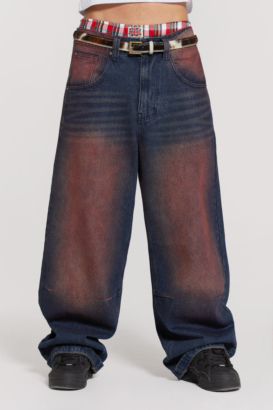 Male wearing red sandblast oversized fit colossus jeans. 