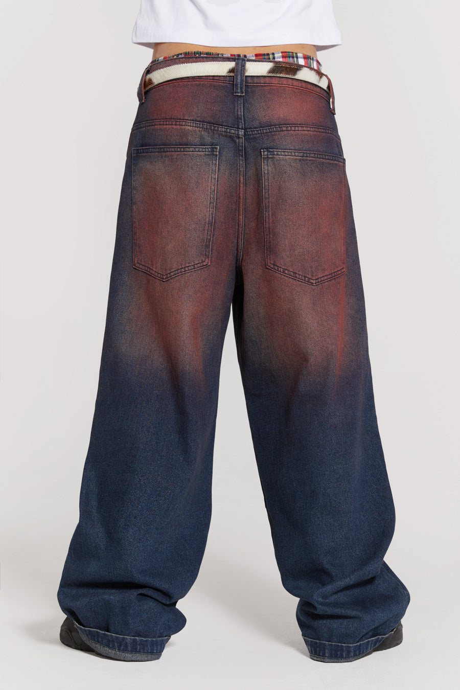 Male wearing red sandblast oversized fit colossus jeans. 