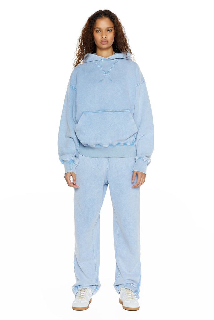 Powder blue oversized hoodie with kangaroo pocket, styled with the matching joggers. 