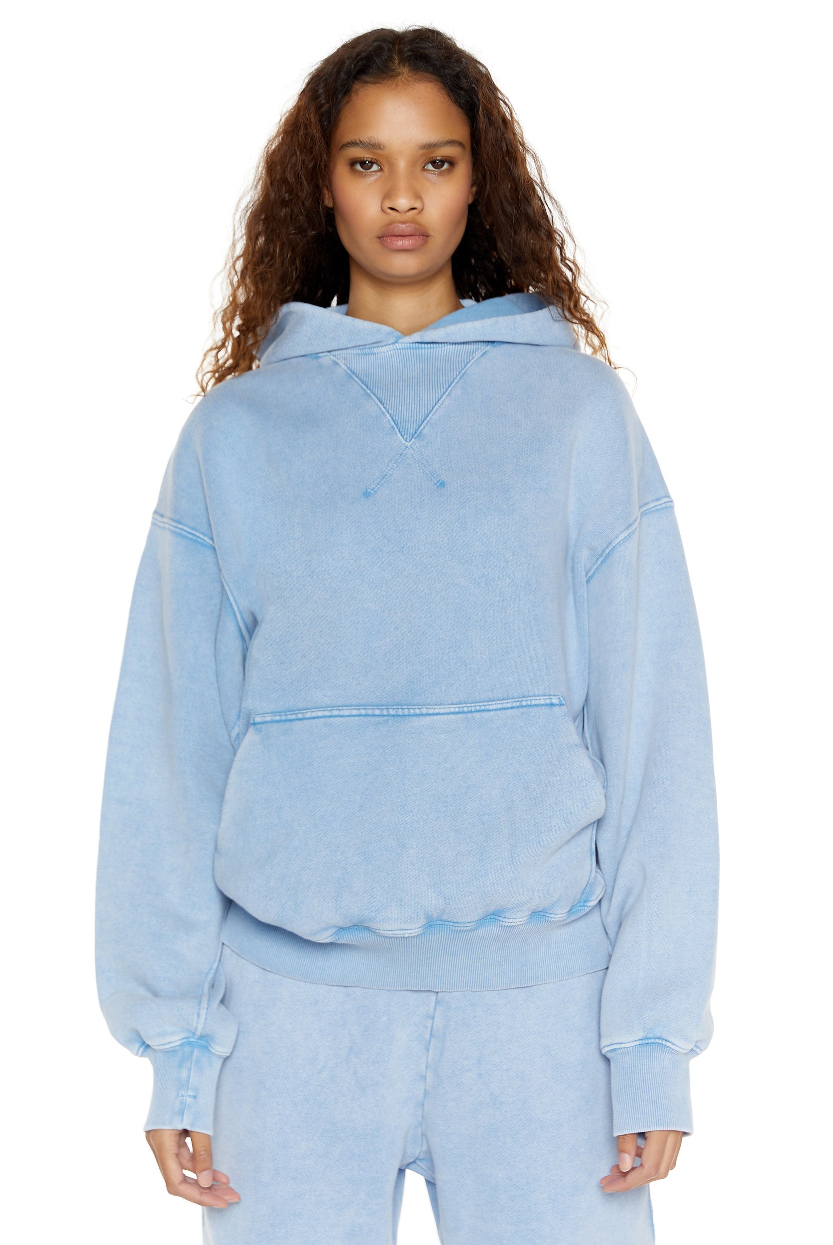 Powder blue oversized hoodie with kangaroo pocket, styled with the matching joggers. 