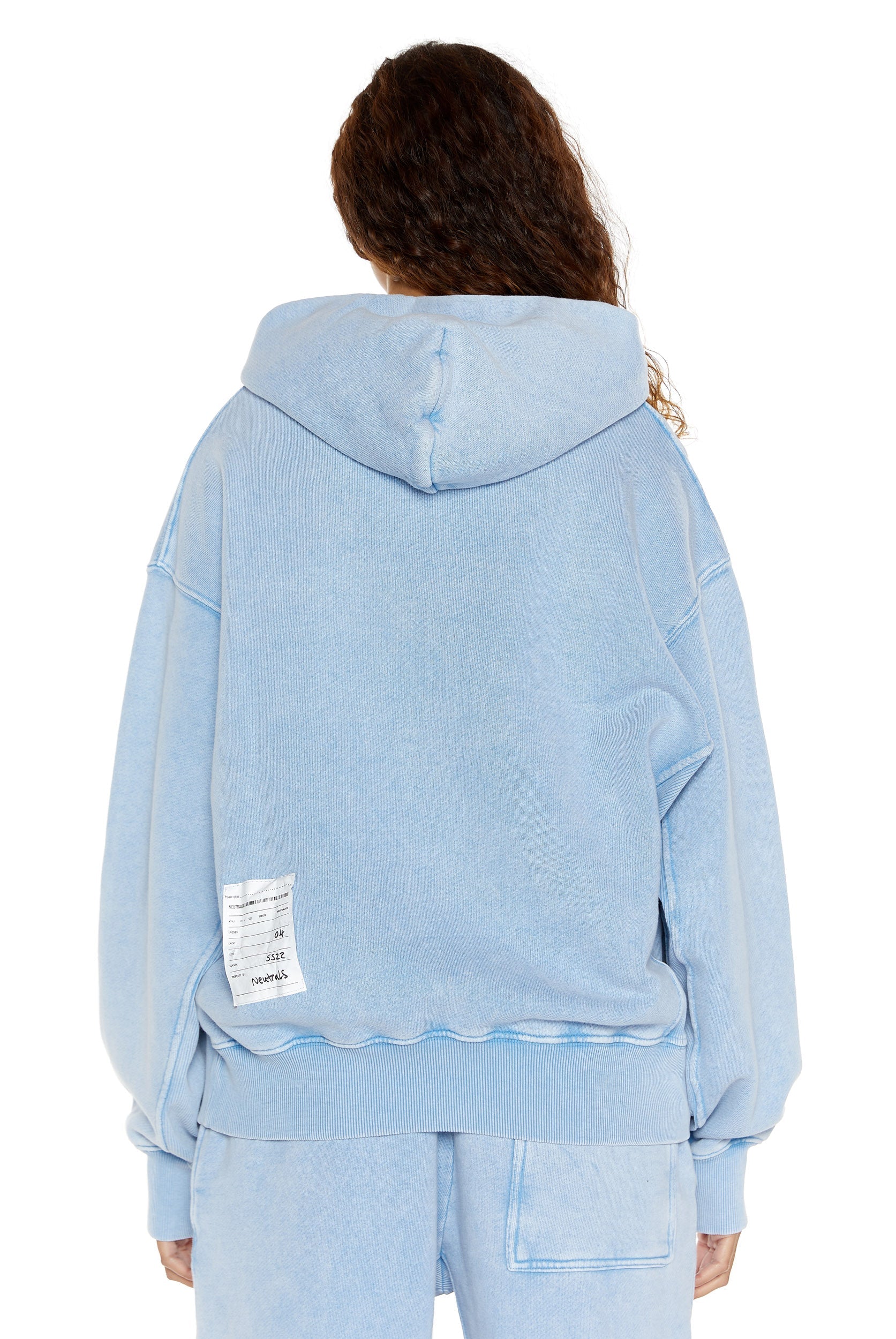 Powder blue oversized hoodie with kangaroo pocket, styled with the matching joggers. 