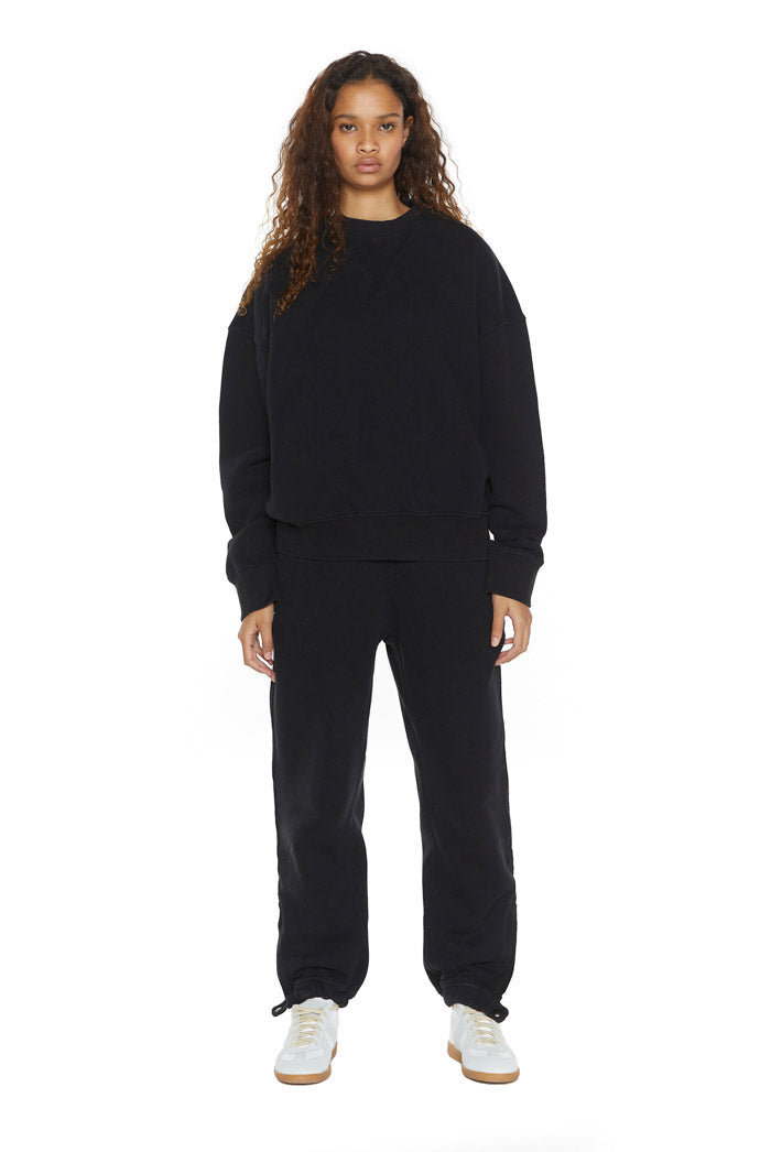 Dust black crew neck oversized sweatshirt with ribbed detailing. Styled with matching joggers. 