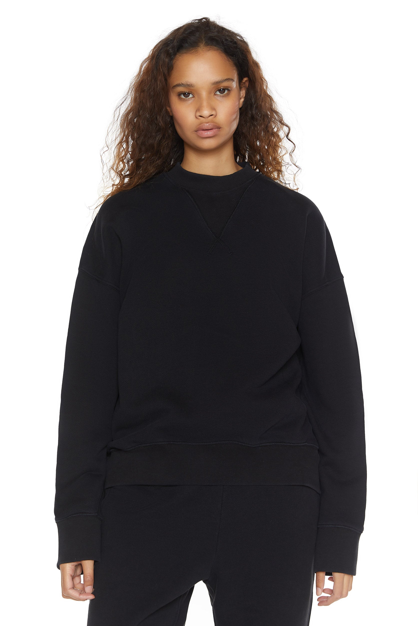 Dust black crew neck oversized sweatshirt with ribbed detailing. Styled with matching joggers. 