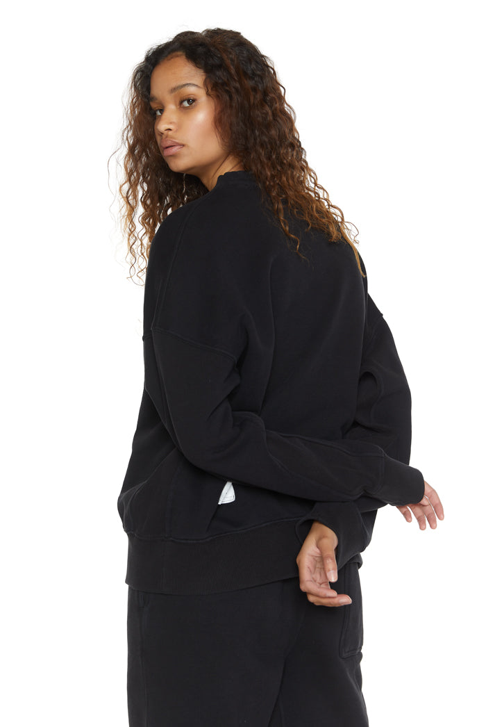 Dust black crew neck oversized sweatshirt with ribbed detailing. Styled with matching joggers. 