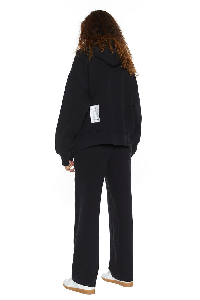 Dust black crew neck oversized sweatshirt with ribbed detailing. Styled with matching joggers. 