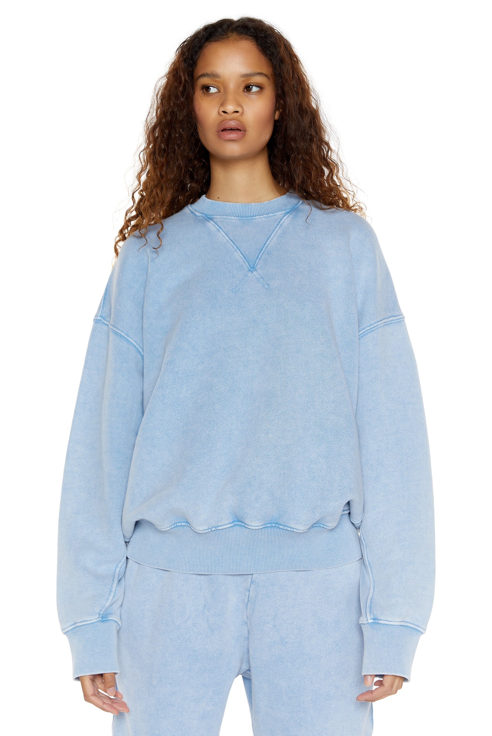 Powder blue oversized crew neck sweatshirt, styled with matching cuffed joggers. 