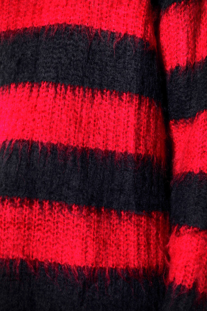 Super close up of black and red knit jumper