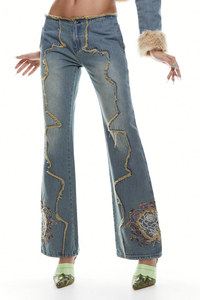 Petite fit light blue denim, low rise boyfriend fit jeans with frayed panel detail and flower embroidery. 