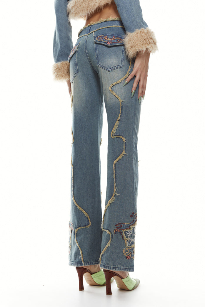 Petite fit light blue denim, low rise boyfriend fit jeans with frayed panel detail and flower embroidery. 