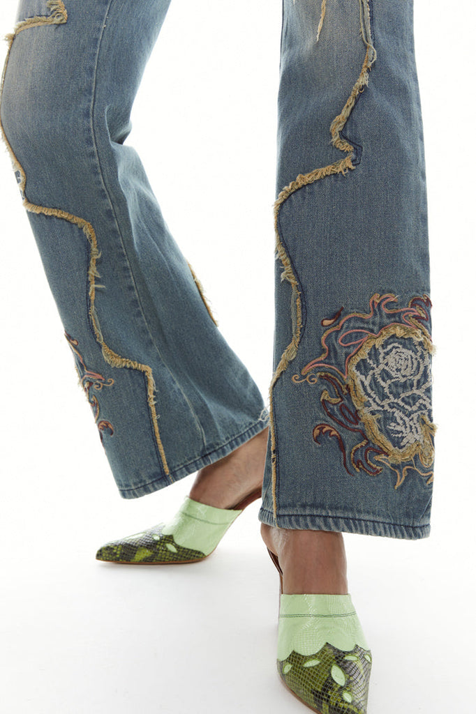 Petite fit light blue denim, low rise boyfriend fit jeans with frayed panel detail and flower embroidery. 