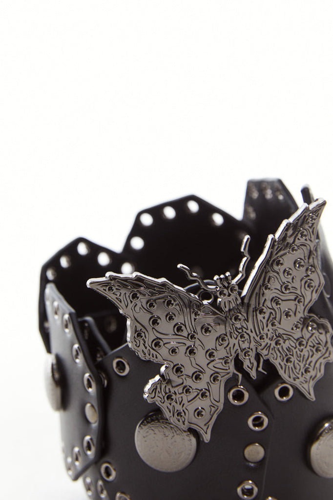 Black concho style belt with silver eyelet detail and silver butterfly pendant.