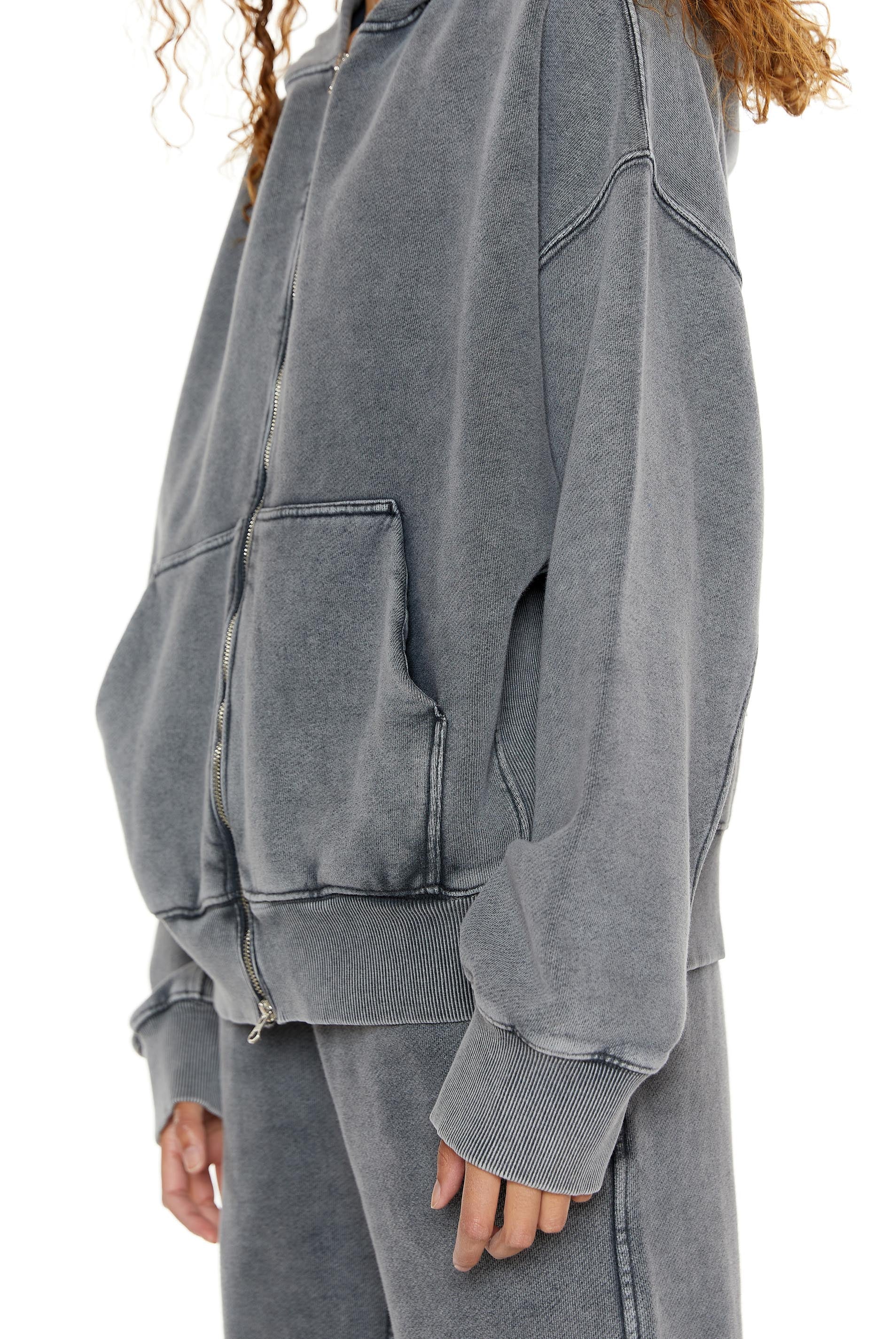 Chrome grey oversized zip up hoodie. Styled with the matching joggers.